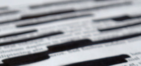 Blurred image of redacted text 